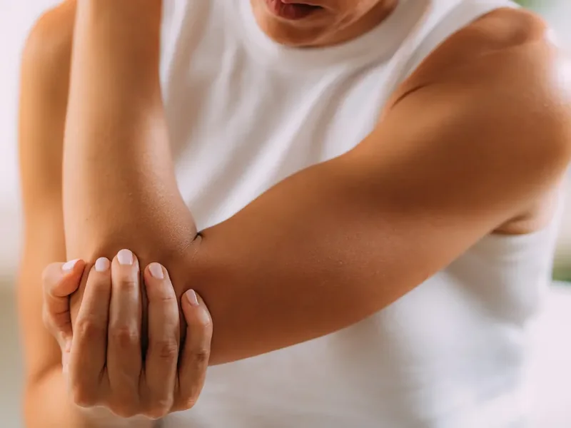 A licensed physical therapist assessing wrist and hand function during an evaluation in Reseda