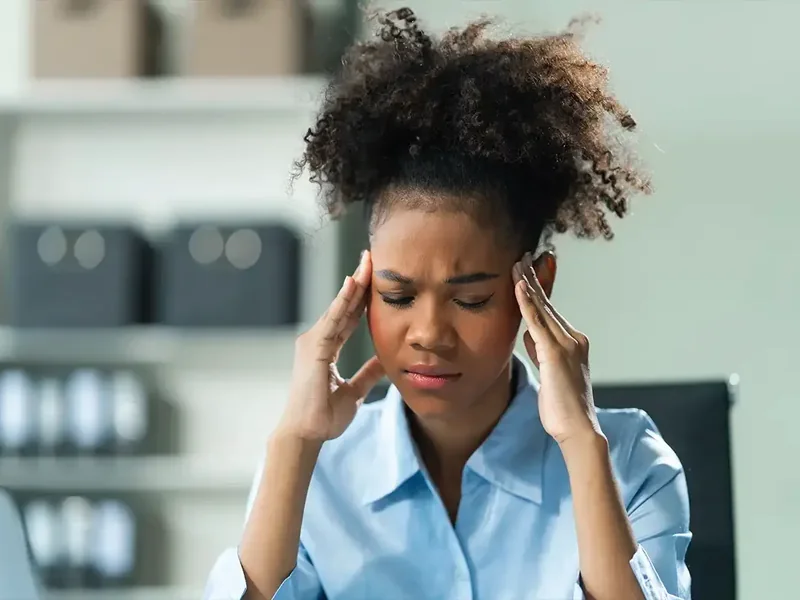 A licensed physical therapist assessing the upper neck during a headache evaluation in Reseda
