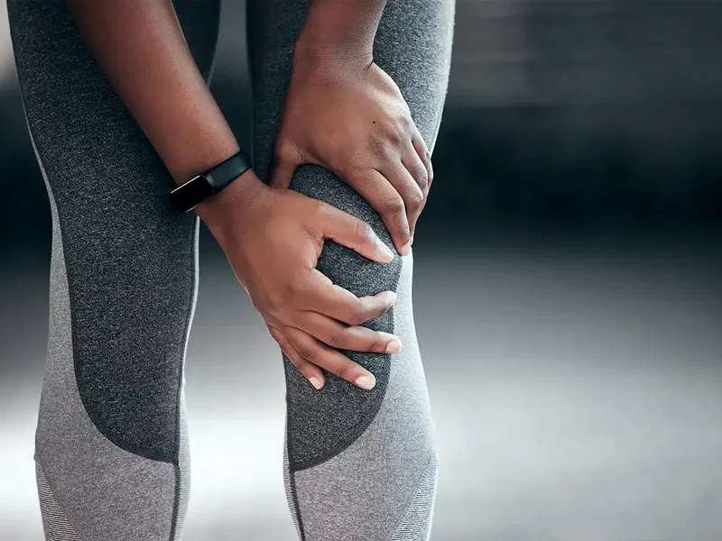 A licensed physical therapist testing knee strength during an evaluation in Reseda