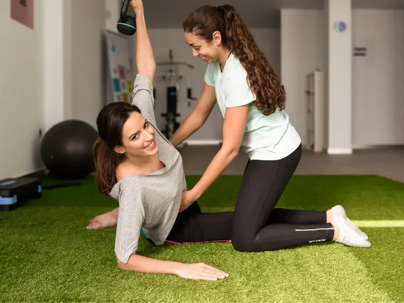 A therapist guiding a patient through a supported stretch to restore motion